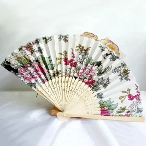 Chinese silk folding fan, white background with pink outlined sketch-style peonies and hot pink plum blossom branches, bamboo ribs