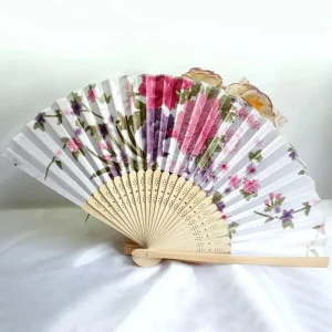 Chinese silk folding fan, white cream background with dense rose and magenta peony clusters, purple asters and pink cherry blossoms, bamboo ribs