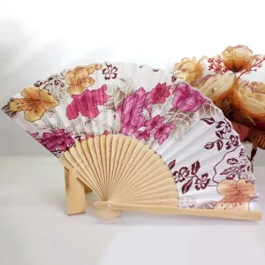 Chinese silk folding fan, white background with amber and hot pink peonies and dark cherry blossom branches, bamboo ribs