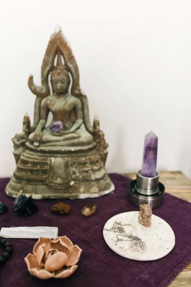 Simple Buddhist home altar with Buddha statue, incense holder, and ritual offerings