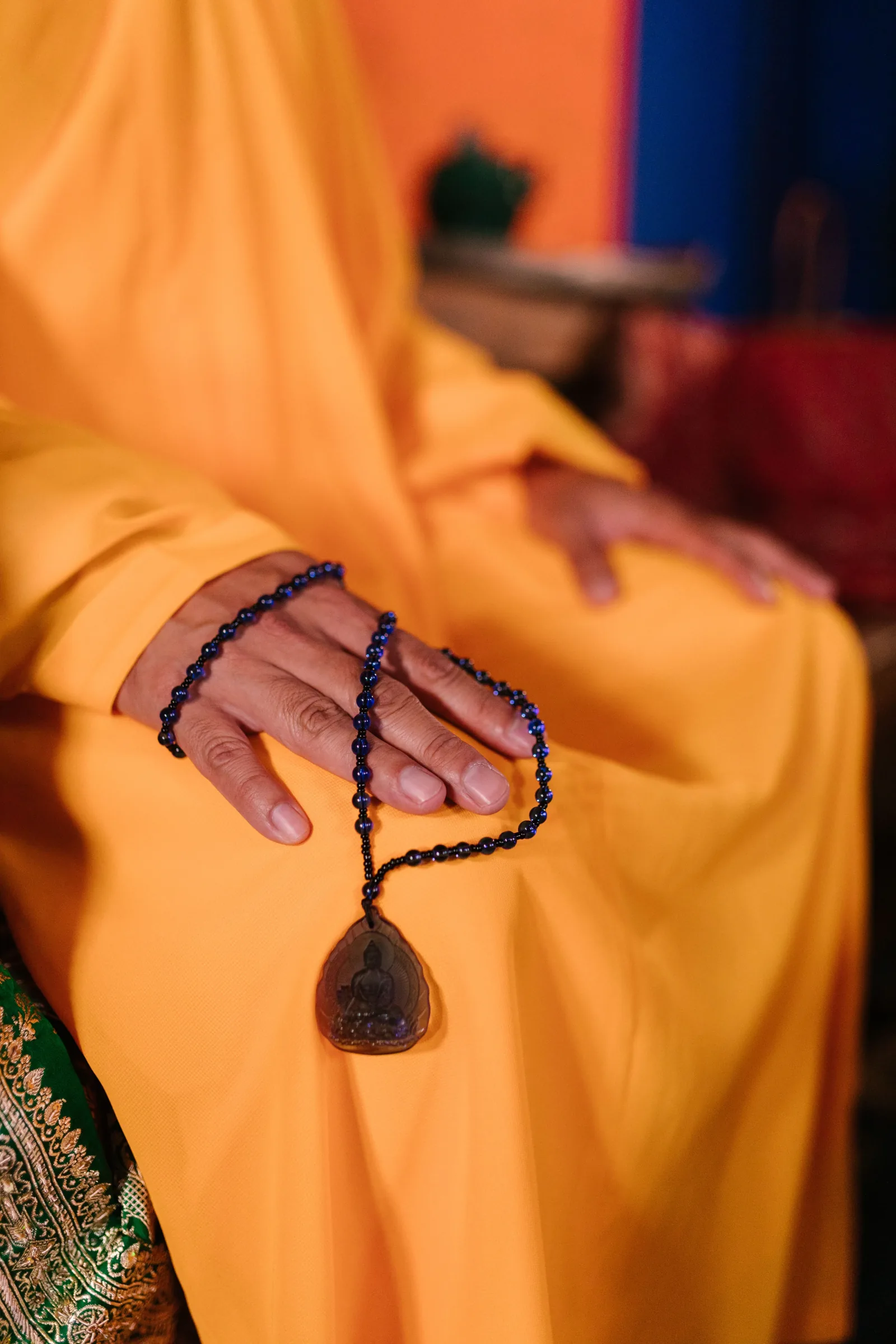 Buddhist monk holding mala beads during prayer — Tibetan tradition, monastery practice