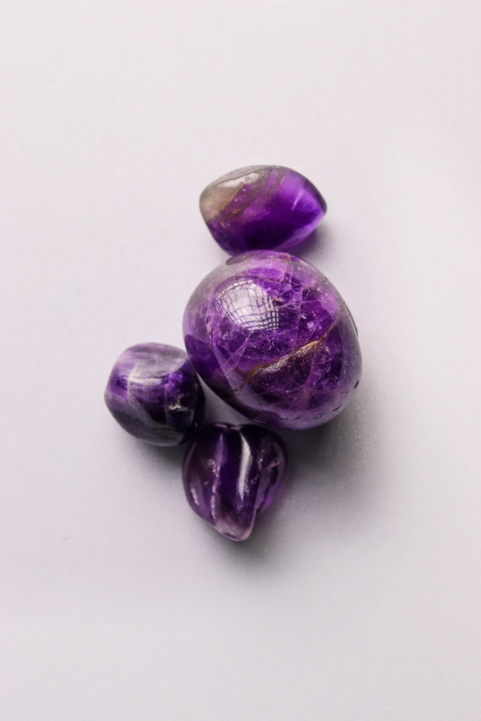 Polished amethyst tumbled stones — deep purple clarity, ready for jewelry and mala use
