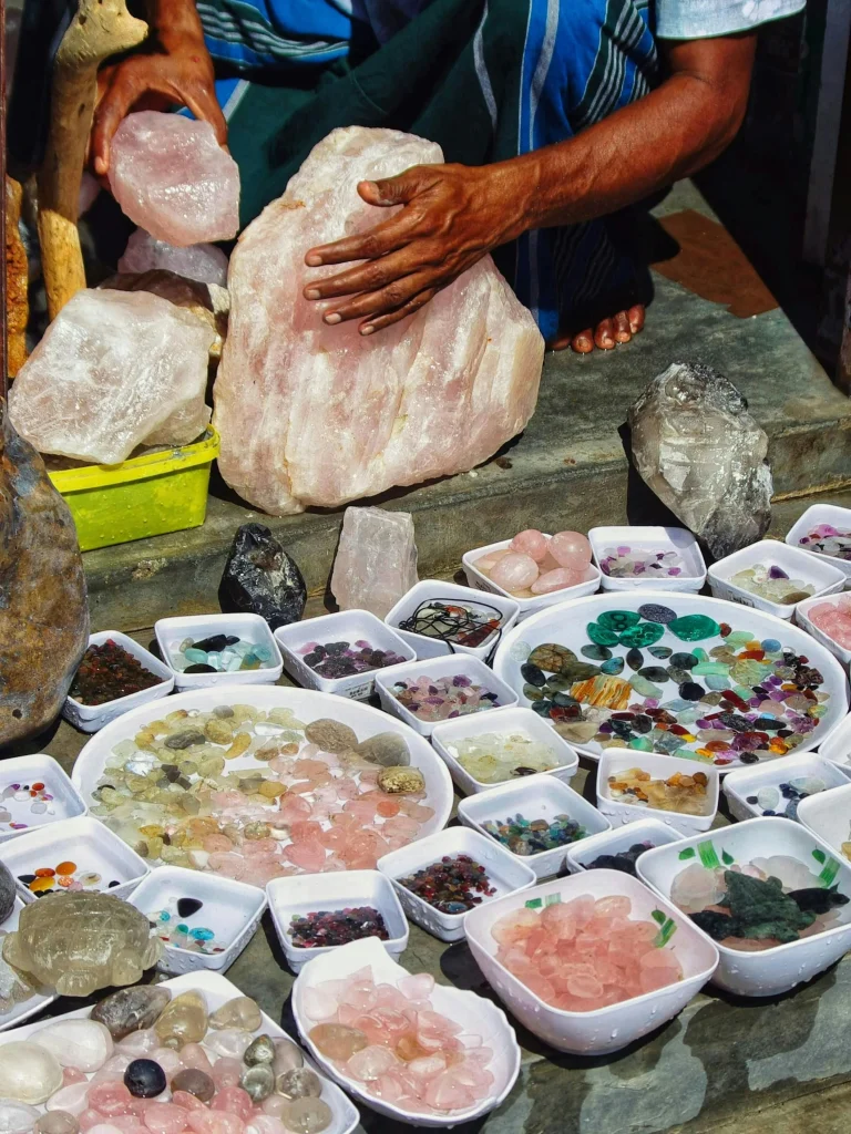 Tibetan craftsman selecting natural agate stones for mala bracelet production — traditional craft process