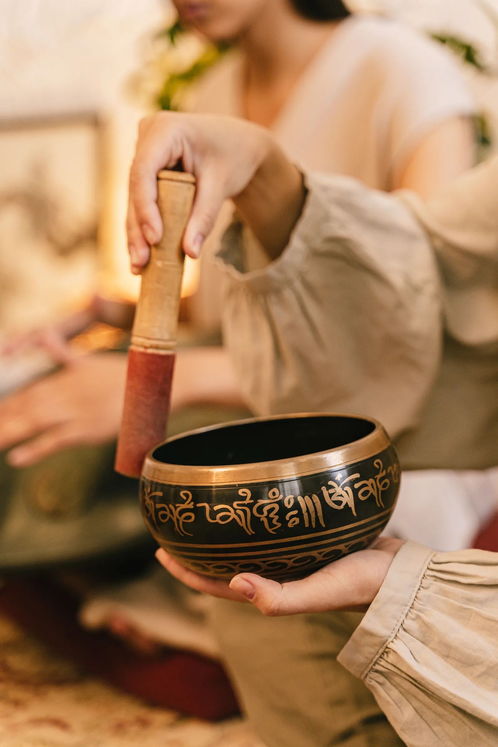 Tibetan singing bowl rim technique — mallet drawn clockwise to sustain resonance