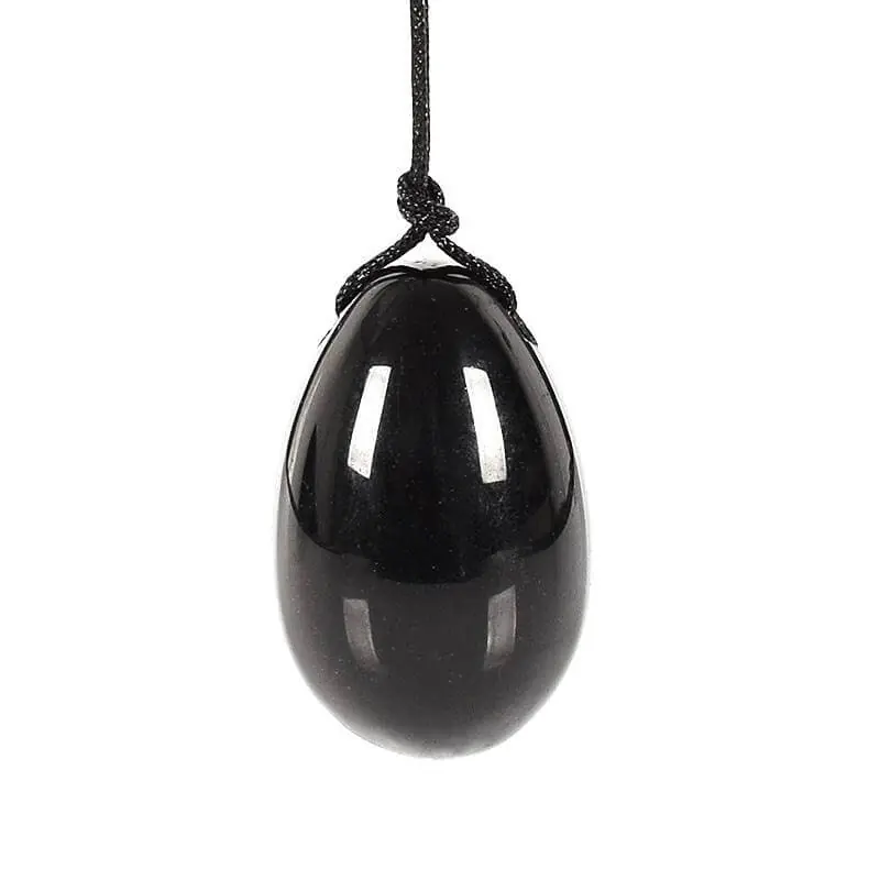 Pierre d'Obsidienne Noire Polie, Forme Ovoïde, Pierre d'obsidienne noire naturelle, polie à la main en forme ovoïde, surface brillante caractéristique du verre volcanique.